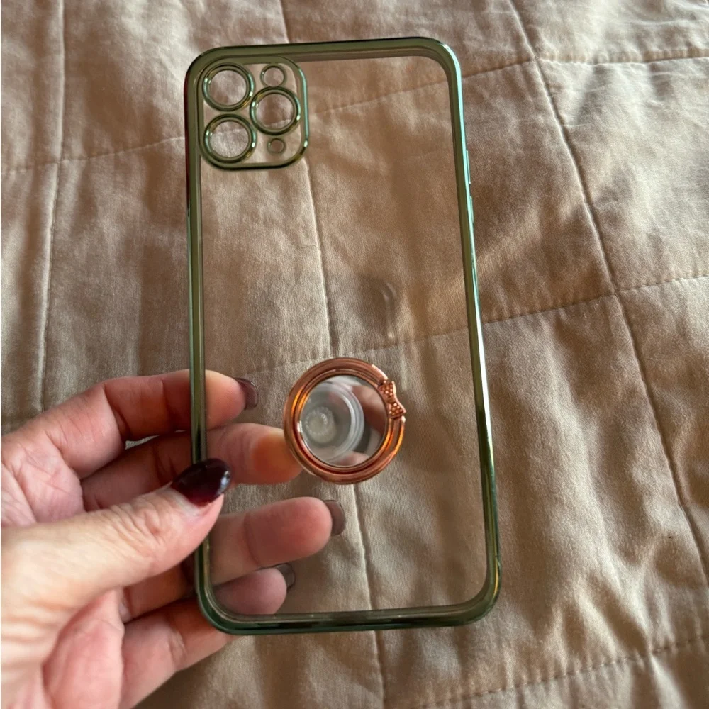 Iphone 11 pro max clear case with green trim. Has a ring phone holder